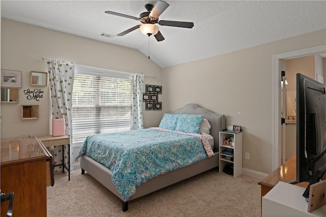 carpeted bedroom featuring ceiling fan, lofted ceiling, and a textured ceiling