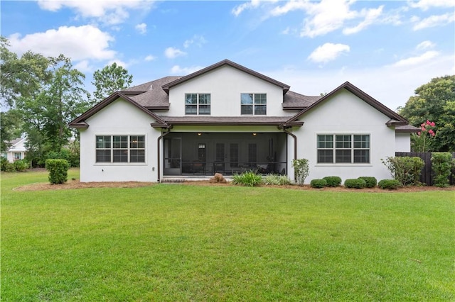 back of house featuring a yard and a sunroom