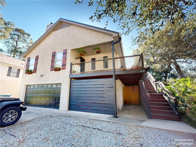 view of front facade with a garage and a balcony