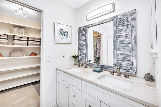 full bathroom with double vanity and a sink