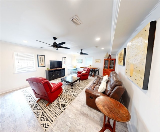 living room with crown molding and hardwood / wood-style flooring