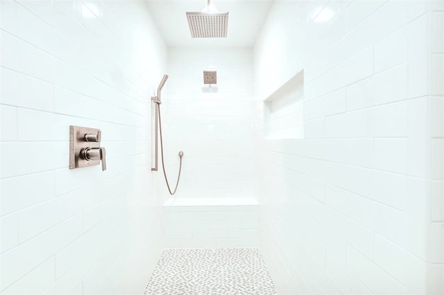 bathroom featuring visible vents and tiled shower