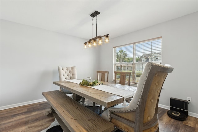dining area featuring wood finished floors and baseboards