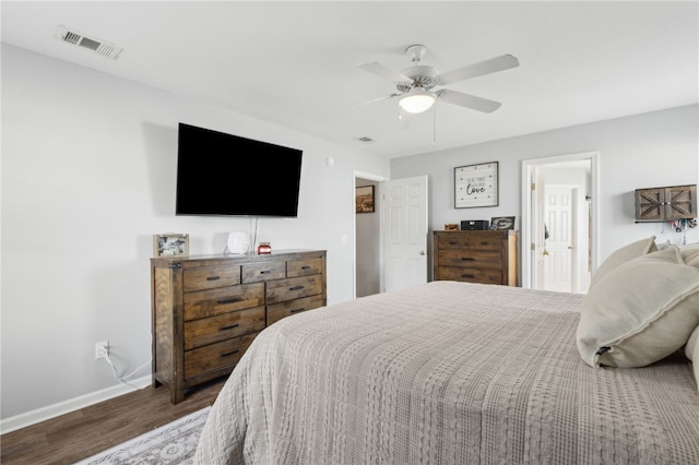 bedroom featuring a ceiling fan, visible vents, wood finished floors, and baseboards