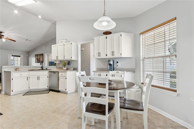 dining space with baseboards, light tile patterned floors, a ceiling fan, and lofted ceiling