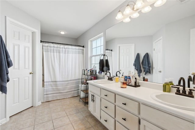 bathroom with shower / bath combo with shower curtain, double vanity, a sink, and tile patterned floors