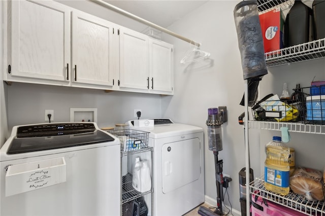 laundry room with baseboards, cabinet space, and independent washer and dryer