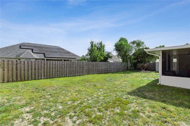 view of yard with a fenced backyard and a sunroom