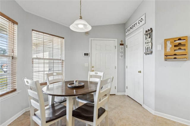 dining area featuring light tile patterned flooring and baseboards