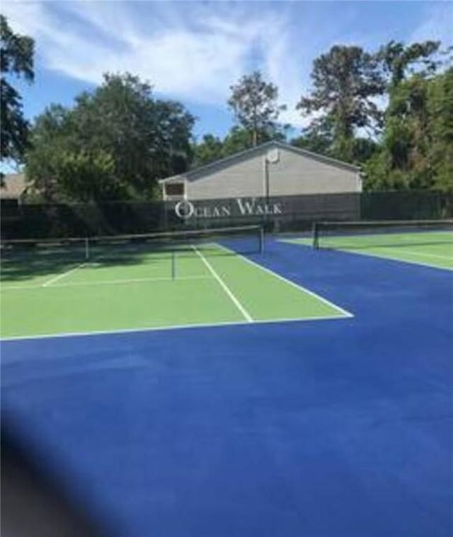 view of tennis court featuring fence