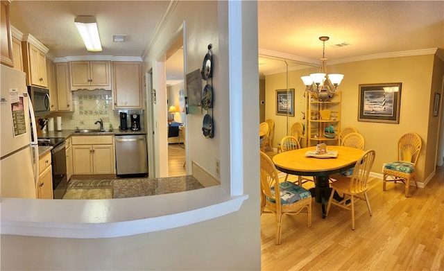850 Mallery St Unit 4S, Saint Simons Island, GA 31522 - kitchen featuring dishwasher, electric range, a chandelier, light wood-style flooring, and crown molding