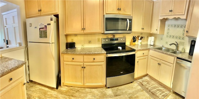 850 Mallery St Unit 4S, Saint Simons Island, GA 31522 - kitchen with appliances with stainless steel finishes, a sink, backsplash, and light stone counters