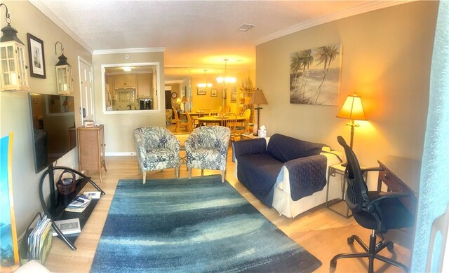 850 Mallery St Unit 4S, Saint Simons Island, GA 31522 - living area featuring wood finished floors, crown molding, a chandelier, and baseboards