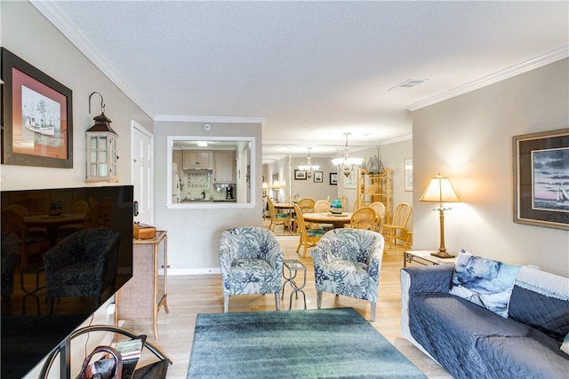 850 Mallery St Unit 4S, Saint Simons Island, GA 31522 - living room with a chandelier, light wood-type flooring, and crown molding