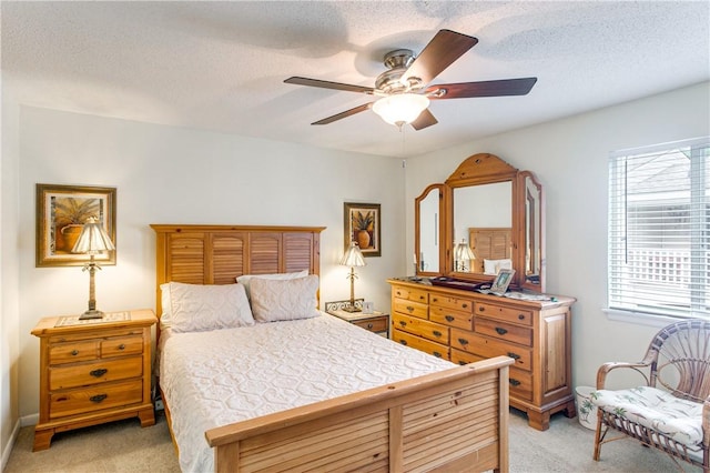 850 Mallery St Unit 4S, Saint Simons Island, GA 31522 - bedroom featuring light colored carpet, multiple windows, a textured ceiling, and a ceiling fan