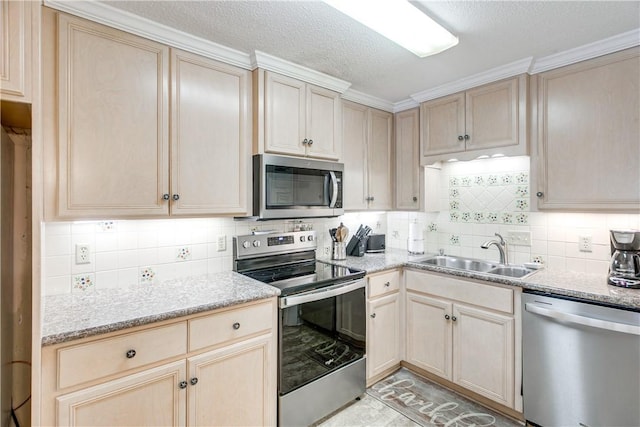 850 Mallery St Unit 4S, Saint Simons Island, GA 31522 - kitchen with appliances with stainless steel finishes, a sink, light brown cabinets, decorative backsplash, and a textured ceiling