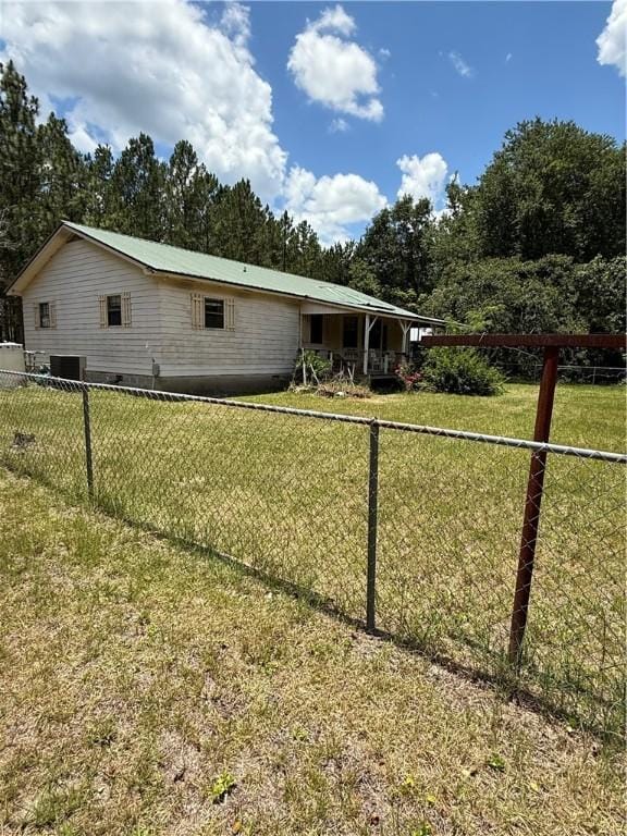 125 Turkey Rdg, Nahunta, GA 31553 - back of house with view of wooded area and a metal roof