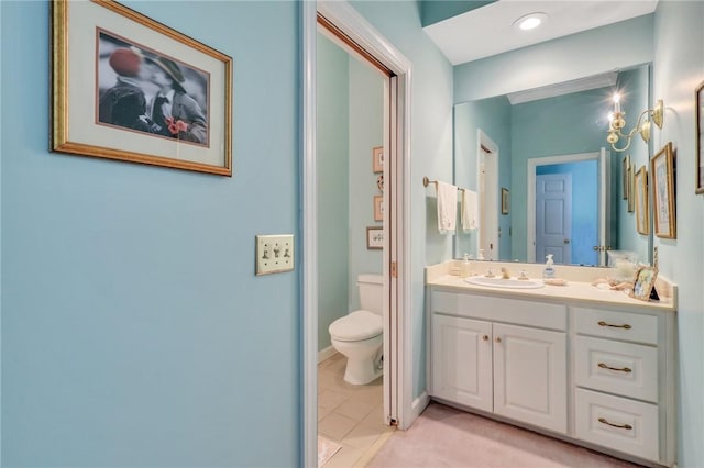 bathroom featuring toilet, tile patterned floors, baseboards, and vanity