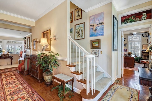 interior space with hardwood / wood-style flooring, baseboards, stairway, and ornamental molding