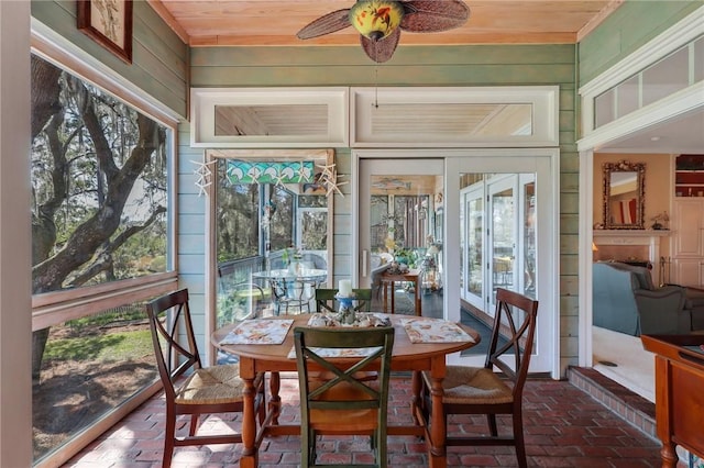 sunroom / solarium with ceiling fan and wooden ceiling