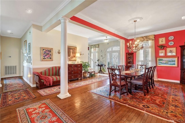 dining room with wood-type flooring, decorative columns, visible vents, and baseboards