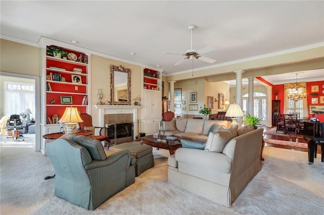 living area with ornate columns, a fireplace, ornamental molding, and a wealth of natural light