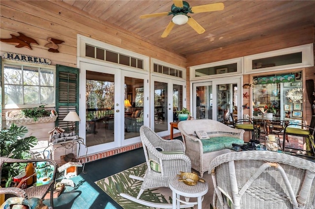 sunroom with ceiling fan, french doors, and wood ceiling