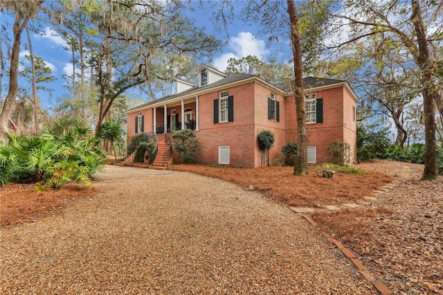 view of front of house featuring covered porch and brick siding