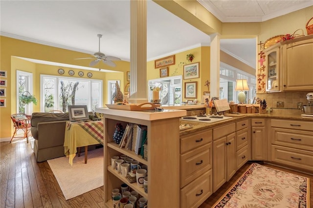 kitchen featuring a peninsula, dark wood-type flooring, open floor plan, white electric cooktop, and crown molding