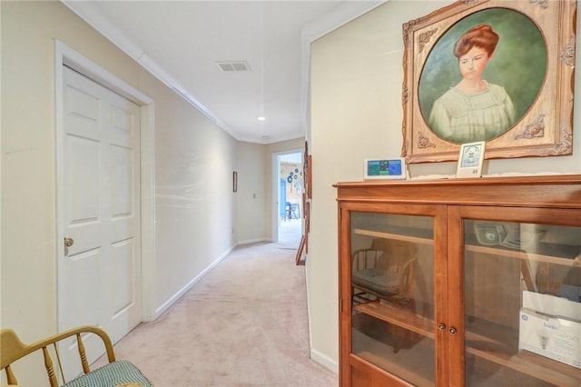 hallway with baseboards, carpet, visible vents, and crown molding