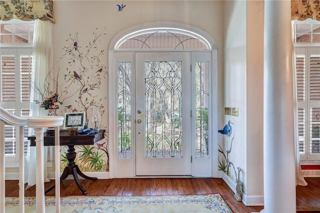 entrance foyer featuring baseboards and wood finished floors