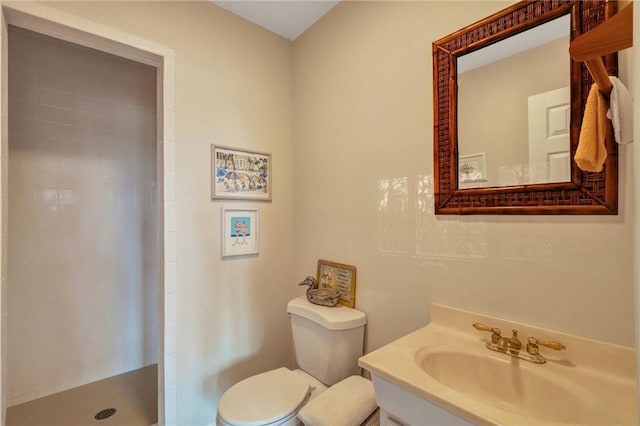 bathroom with vanity, a shower stall, and toilet