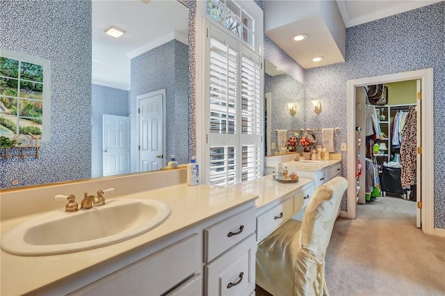 bathroom featuring recessed lighting, a walk in closet, vanity, and wallpapered walls