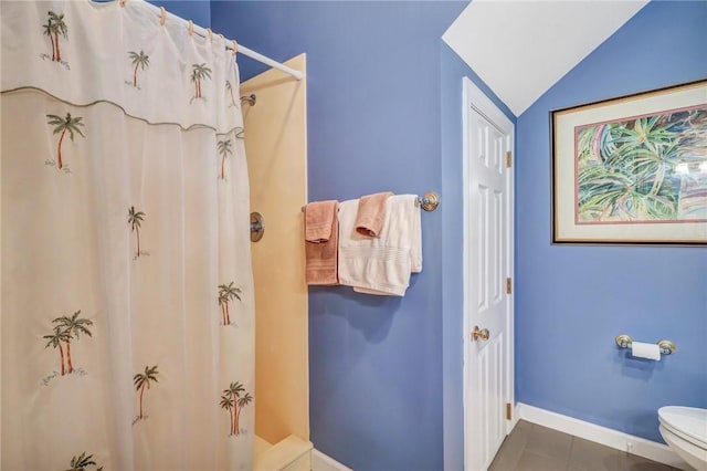 full bathroom with curtained shower, tile patterned floors, toilet, and baseboards