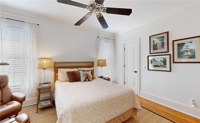 bedroom with hardwood / wood-style floors, ceiling fan, and ornamental molding