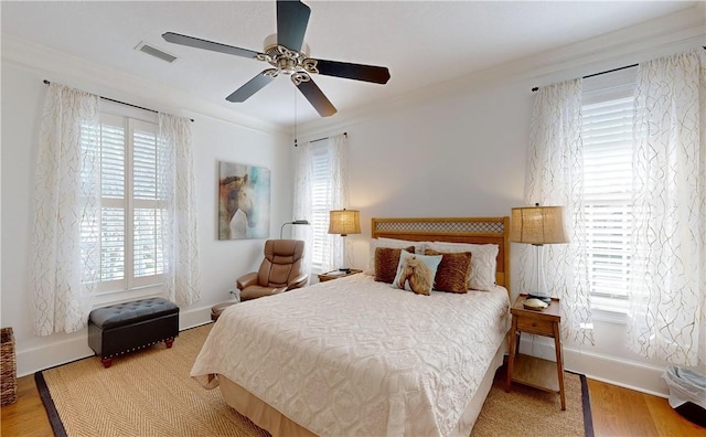 bedroom featuring ceiling fan, crown molding, and light wood-type flooring