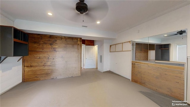 interior space with ceiling fan and crown molding