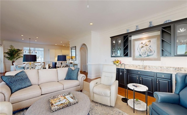 living room with ornamental molding and sink