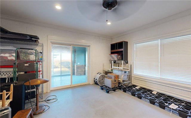 miscellaneous room featuring ceiling fan, concrete flooring, and ornamental molding