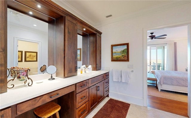 bathroom with hardwood / wood-style flooring, vanity, ceiling fan, and ornamental molding