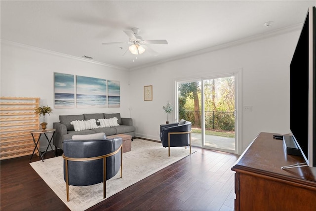 living room with stairway, a ceiling fan, visible vents, dark wood finished floors, and crown molding