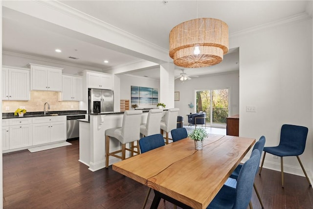 dining room with ornamental molding, recessed lighting, baseboards, ceiling fan, and dark wood-style flooring