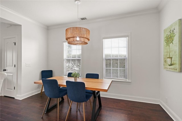 dining space with visible vents, wood finished floors, and ornamental molding