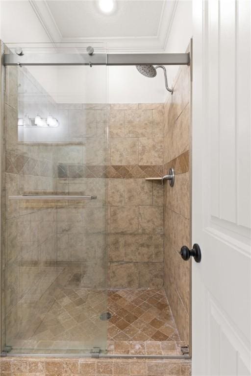 full bath featuring crown molding and a stall shower