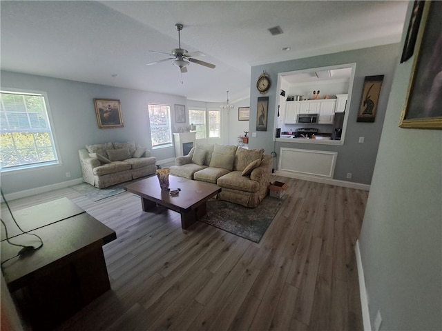 1002 Baltimore Ave, Waycross, GA 31501 - living area with a ceiling fan, wood finished floors, and baseboards