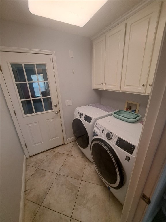 1002 Baltimore Ave, Waycross, GA 31501 - laundry room featuring independent washer and dryer, cabinet space, light tile patterned floors, and baseboards
