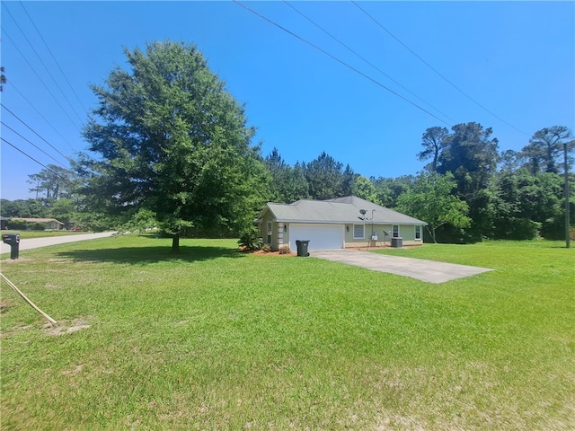 1002 Baltimore Ave, Waycross, GA 31501 - view of grassy yard with an attached garage, driveway, and cooling unit