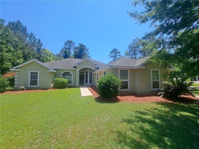 1002 Baltimore Ave, Waycross, GA 31501 - view of front facade featuring stucco siding and a front lawn