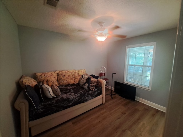 1002 Baltimore Ave, Waycross, GA 31501 - bedroom with wood finished floors, baseboards, ceiling fan, and a textured ceiling