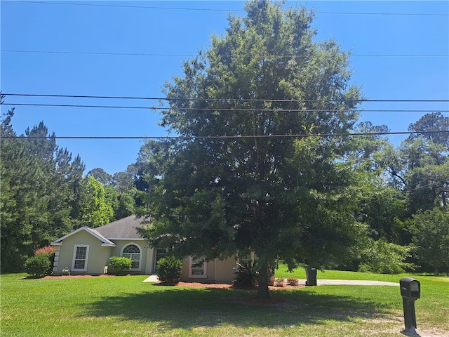 1002 Baltimore Ave, Waycross, GA 31501 - obstructed view of property featuring a front yard and stucco siding